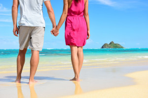 Couple holding hands on the beach